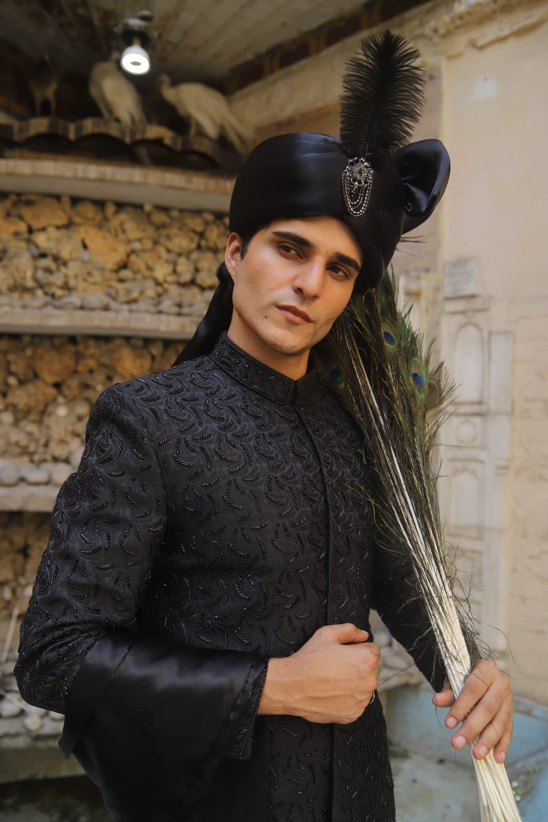 Kudmayi Tajdaar black prince coat with tonal beadwork, styled with a black turban and brooch.
