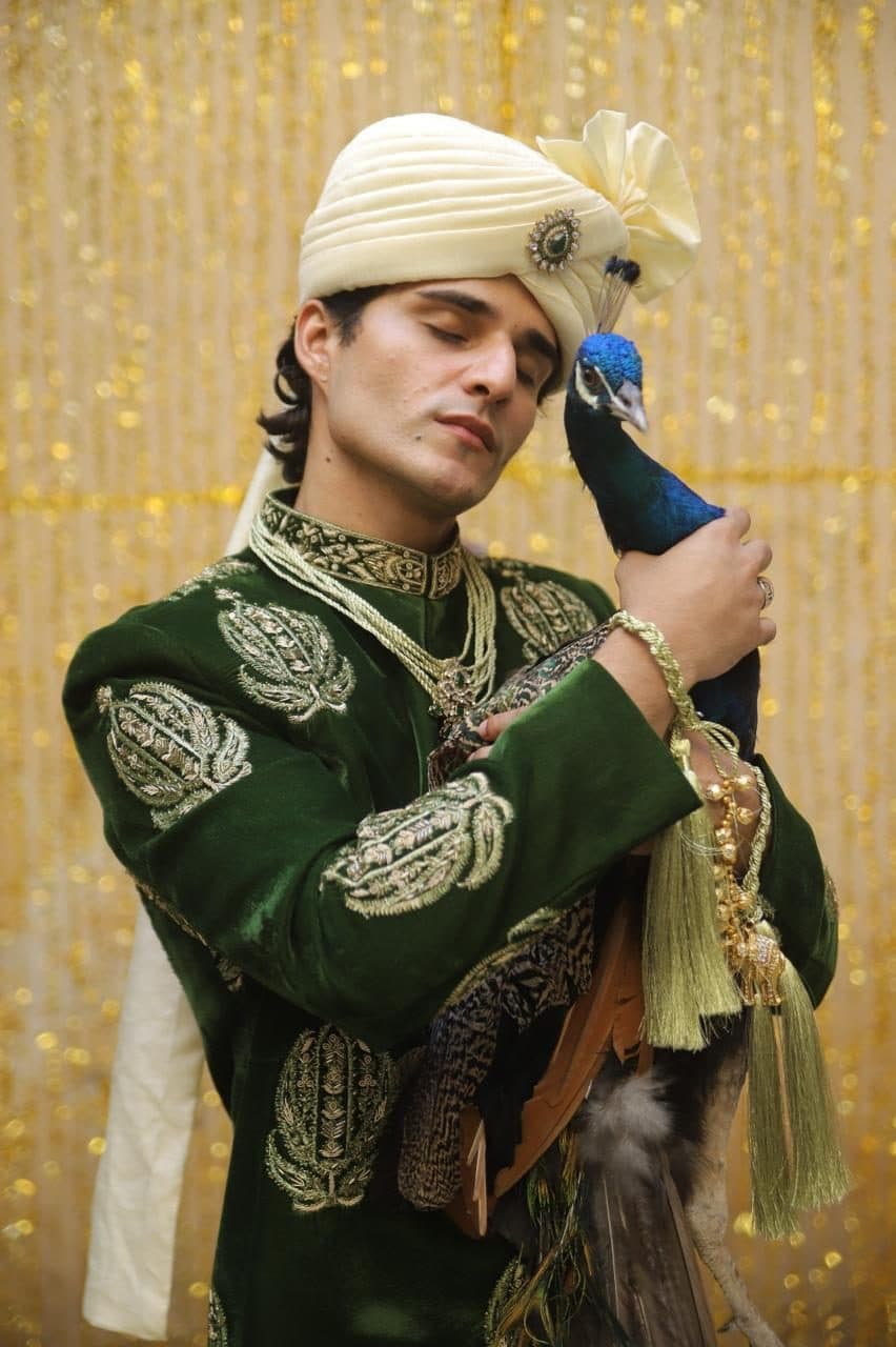 Kudmayi Shehnai emerald velvet sherwani with gold motifs and an ivory turban.