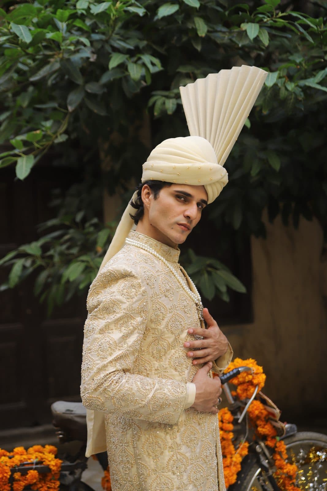 Kudmayi Zarr E Shaan ivory-gold sherwani with tonal embroidery and a cream turban.