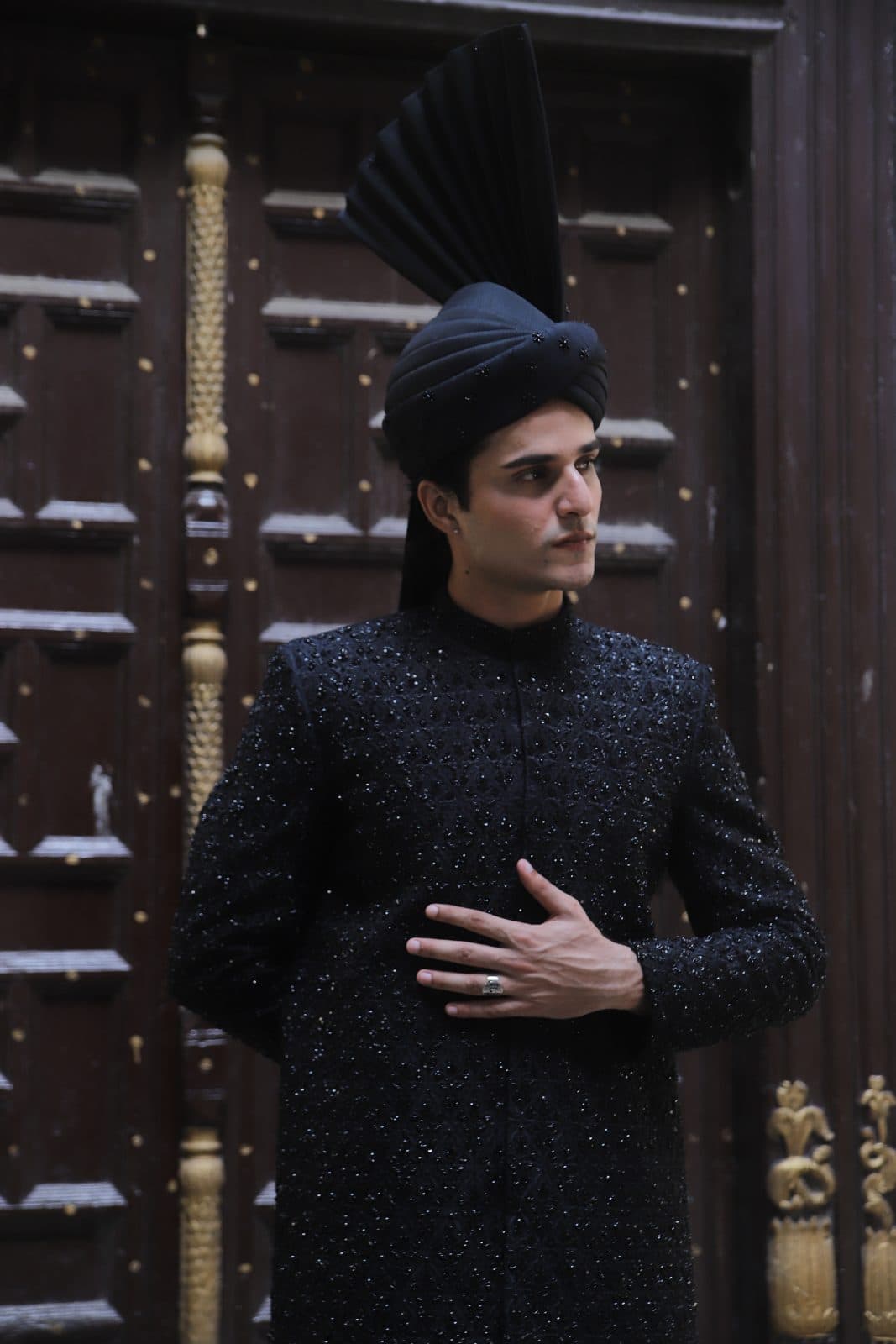 Kudmayi Shab E Aswad black sherwani with tonal beadwork and a black turban.